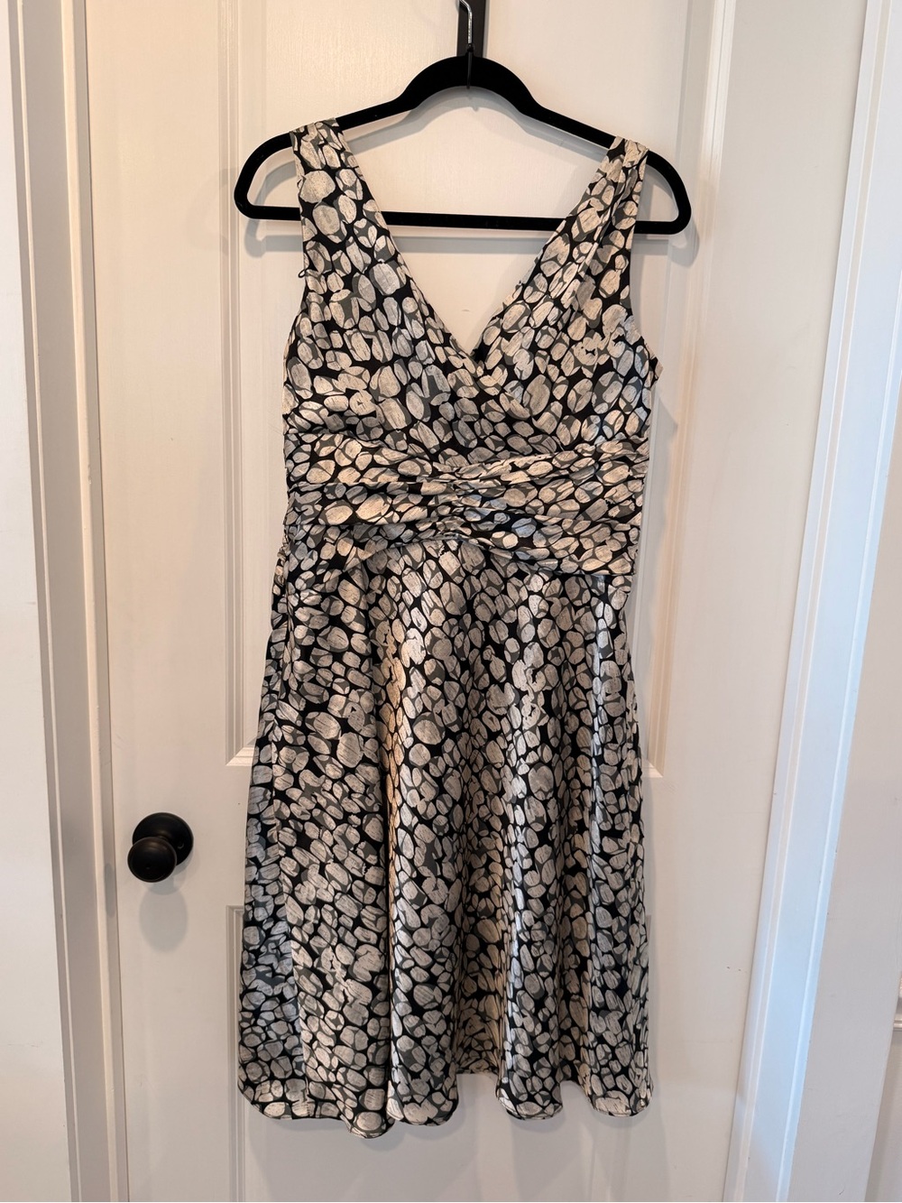 Black and ivory sleeveless fit-and-flare dress with an abstract pebble print.